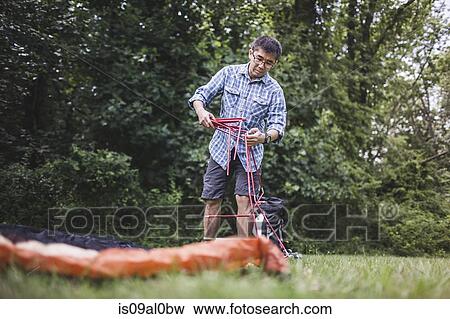 Mature man putting up tent View Large Photo Image Stock Photo - Mature man putting up tent. Fotosearch