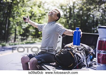 Mature man sitting on pick up truck with arms out View Large Photo Image Stock Image - Mature man sitting on pick up truck with arms out. Fotosearch