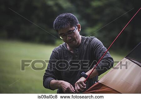 Mature man taking down tent View Large Photo Image Stock Photo - Mature man taking down tent. Fotosearch