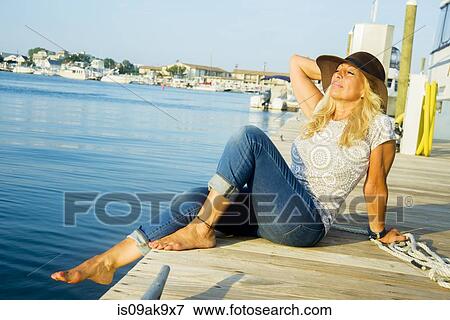 Mature woman sitting on harbor pier with eyes closed, Monmouth Beach, New Jersey, USA View Large Photo Image Stock Photo - Mature woman sitting on harbor pier with eyes closed, Monmouth Beach, New Jersey, USA. Fotosearch