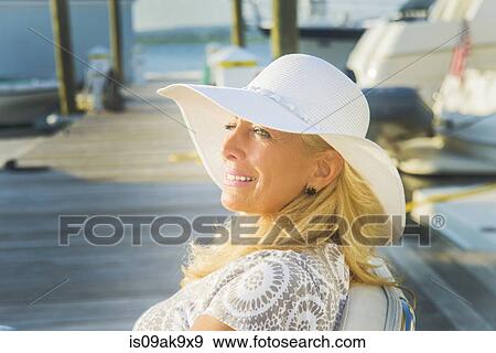 Mature woman sitting on harbor pier, Monmouth Beach, New Jersey, USA View Large Photo Image Stock Photo - Mature woman sitting on harbor pier, Monmouth Beach, New Jersey, USA. Fotosearch