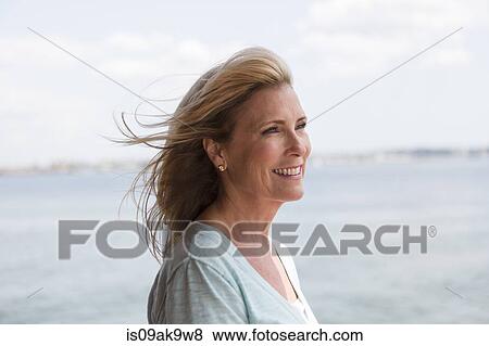 Stock Photo - Mature woman with blonde hair, portrait. Fotosearch