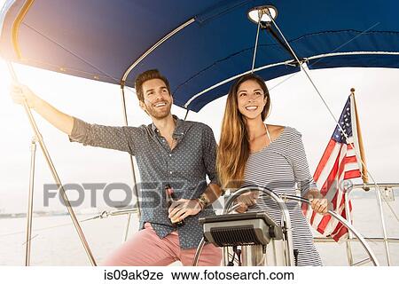 Mid adult couple on sailing boat View Large Photo Image Stock Image - Mid adult couple on sailing boat. Fotosearch
