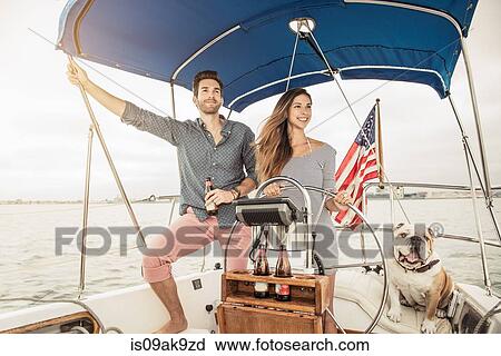 Mid adult couple on sailing boat with dog View Large Photo Image Stock Image - Mid adult couple on sailing boat with dog. Fotosearch