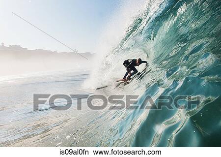 Mid adult man surfing rolling wave, Leucadia, California, USA View Large Photo Image Picture - Mid adult man surfing rolling wave, Leucadia, California, USA. Fotosearch