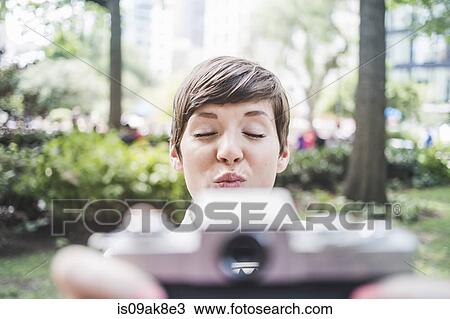 Stock Image - Photographer pouting for selfie. Fotosearch