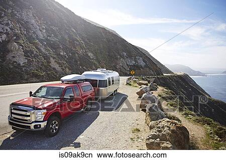 Picture - Pick-up truck with trailer attached on mountain road, Big Sur, California, USA. Fotosearch