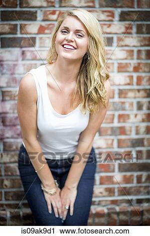 Portrait of a happy young woman looking at camera View Large Photo Image Stock Image - Portrait of a happy young woman looking at camera. Fotosearch