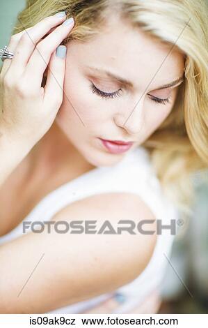 Portrait of a young woman, looking down View Large Photo Image Stock Photo - Portrait of a young woman, looking down. Fotosearch