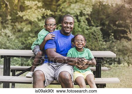 Portrait of father with son and daughter at parkland eco camp View Large Photo Image Stock Photograph - Portrait of father with son and daughter at parkland eco camp. Fotosearch