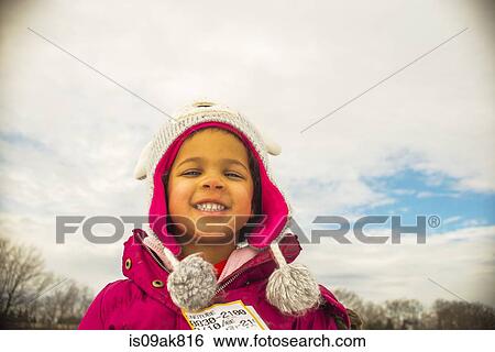 Stock Photograph - Portrait of girl in knit hat with eyes closed. Fotosearch