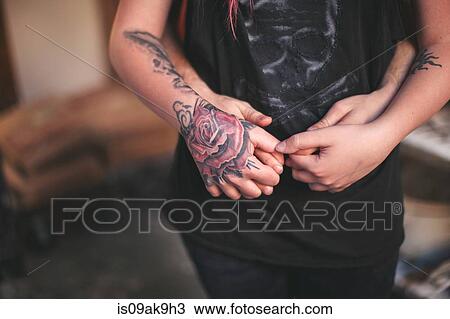Tattooed hand holding person behind View Large Photo Image Stock Image - Tattooed hand holding person behind. Fotosearch