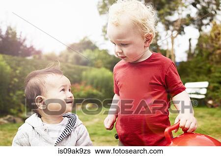 Two baby boys looking at each other View Large Photo Image Stock Photograph - Two baby boys looking at each other. Fotosearch