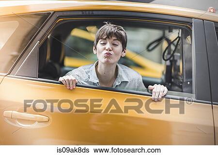 Woman blowing kiss from yellow taxi, New York, US View Large Photo Image Stock Photograph - Woman blowing kiss from yellow taxi, New York, US. Fotosearch