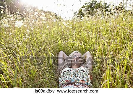 Woman in field of wildflowers View Large Photo Image Stock Photo - Woman in field of wildflowers. Fotosearch