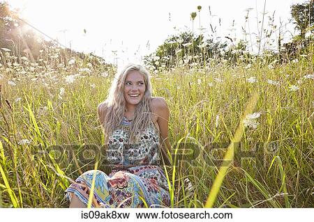 Woman in field of wildflowers View Large Photo Image Stock Photo - Woman in field of wildflowers. Fotosearch