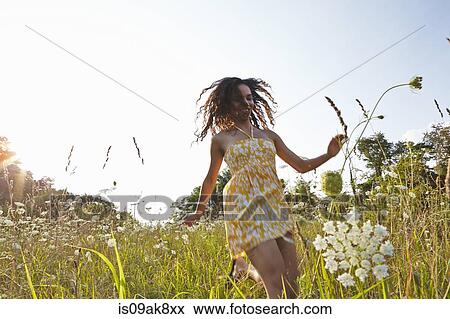Woman in field of wildflowers View Large Photo Image Stock Photo - Woman in field of wildflowers. Fotosearch