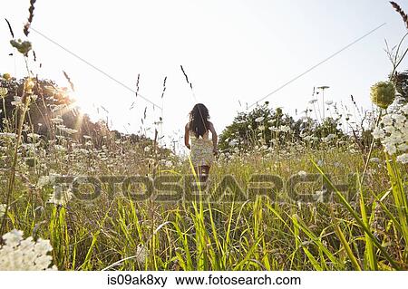Woman in field of wildflowers View Large Photo Image Stock Photo - Woman in field of wildflowers. Fotosearch