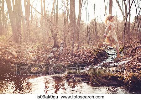 Stock Photograph - Woman in forest. Fotosearch