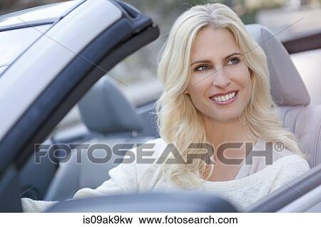 Stock Photo - Woman in her convertible car. Fotosearch