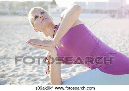Woman in yoga prayer pose on the beach View Large Photo Image Stock Image - Woman in yoga prayer pose on the beach. Fotosearch