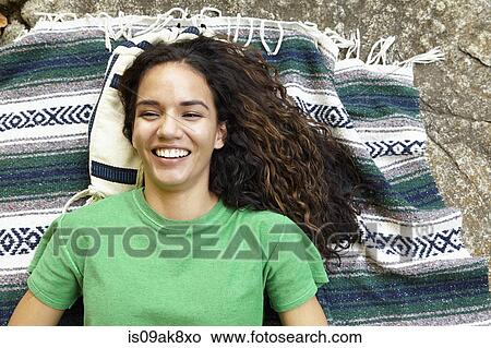 Picture - Woman lying on blanket. Fotosearch