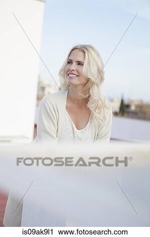Stock Image - Woman on rooftop. Fotosearch