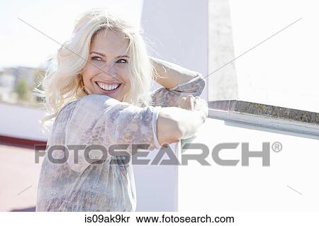 Stock Photography - Woman on rooftop. Fotosearch