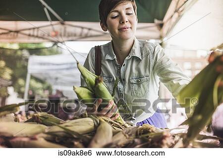 Woman shopping at vegetable market View Large Photo Image Stock Photograph - Woman shopping at vegetable market. Fotosearch