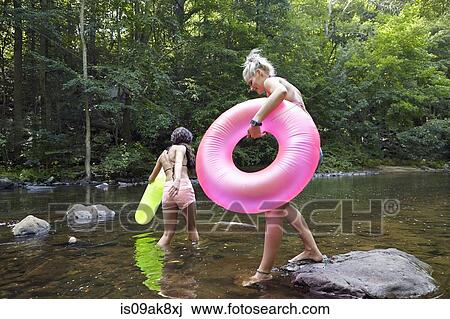 Women in river with inflatable rings View Large Photo Image Stock Image - Women in river with inflatable rings. Fotosearch