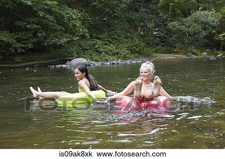 Women in river with inflatable rings View Large Photo Image Stock Image - Women in river with inflatable rings. Fotosearch