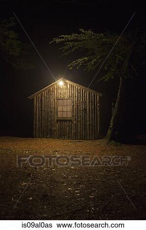 Wooden shed with electric light at night View Large Photo Image Stock Photograph - Wooden shed with electric light at night. Fotosearch