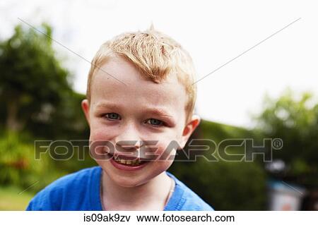 Stock Photo - Young boy smiling, portrait. Fotosearch