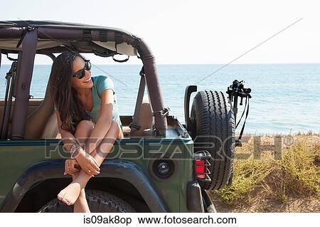 Young woman sitting in jeep window, Malibu, California, USA View Large Photo Image Stock Photography - Young woman sitting in jeep window, Malibu, California, USA. Fotosearch