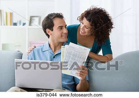 Couple looking at home finances on computer View Large Photo Image Picture - Couple looking at home finances on computer. Fotosearch