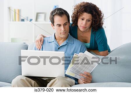 Couple looking at home finances on computer View Large Photo Image Stock Image - Couple looking at home finances on computer. Fotosearch