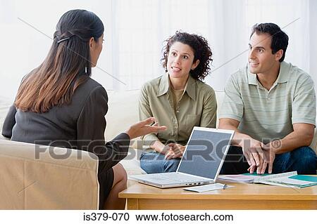 Stock Image - Couple talking to a financial advisor . Fotosearch