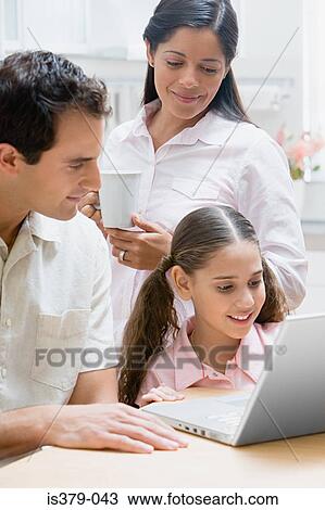 Family using a laptop computer View Large Photo Image Stock Image - Family using a laptop computer. Fotosearch