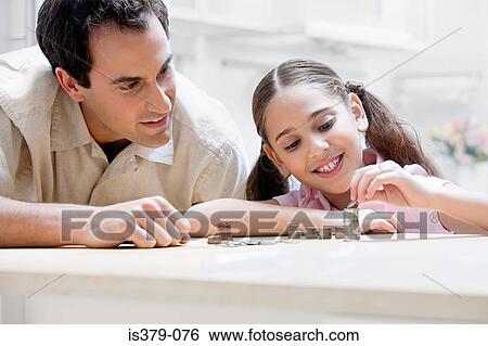Father and daughter with coins View Large Photo Image Stock Photograph - Father and daughter with coins. Fotosearch