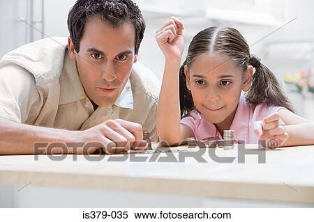 Stock Photography - Father and daughter with coins. Fotosearch