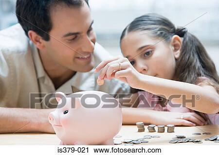 Stock Image - Father and daughter with piggy bank. Fotosearch