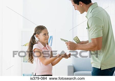Father giving daughter pocket money View Large Photo Image Picture - Father giving daughter pocket money. Fotosearch