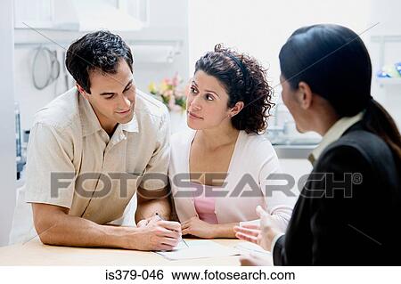 Stock Photograph - Financial advisor with couple. Fotosearch
