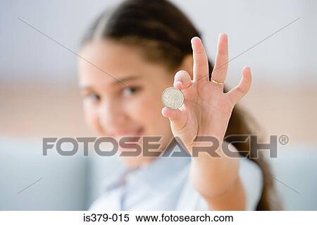 Stock Photography - Girl holding a coin. Fotosearch