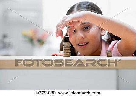 Girl placing coin on stack View Large Photo Image Stock Image - Girl placing coin on stack. Fotosearch