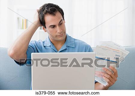 Man with bills and a laptop computer View Large Photo Image Stock Photography - Man with bills and a laptop computer. Fotosearch