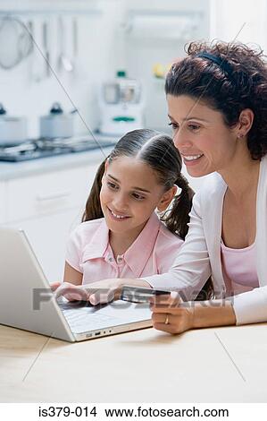 Mother and daughter online shopping View Large Photo Image Picture - Mother and daughter online shopping. Fotosearch