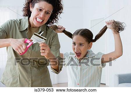 Stock Image - Mother cutting up a credit card. Fotosearch
