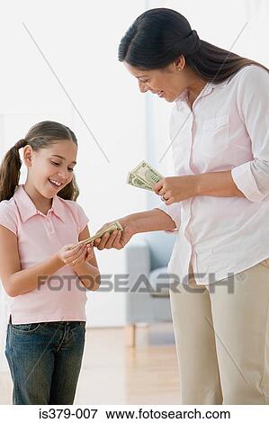 Mother giving daughter pocket money View Large Photo Image Stock Photo - Mother giving daughter pocket money. Fotosearch