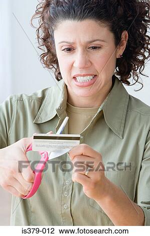 Woman cutting up a credit card View Large Photo Image Stock Image - Woman cutting up a credit card. Fotosearch